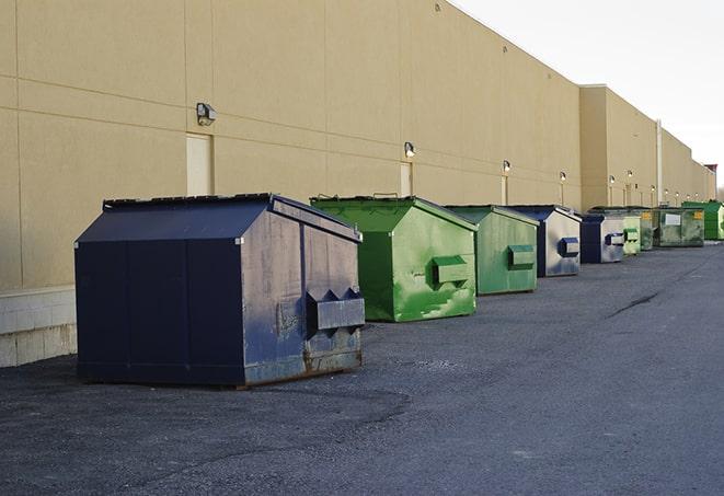 construction waste being loaded into large dumpsters in Alpine